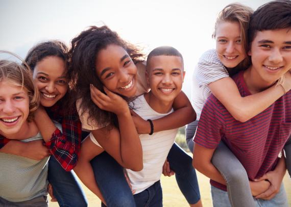 Various race school kids laughing and playing together